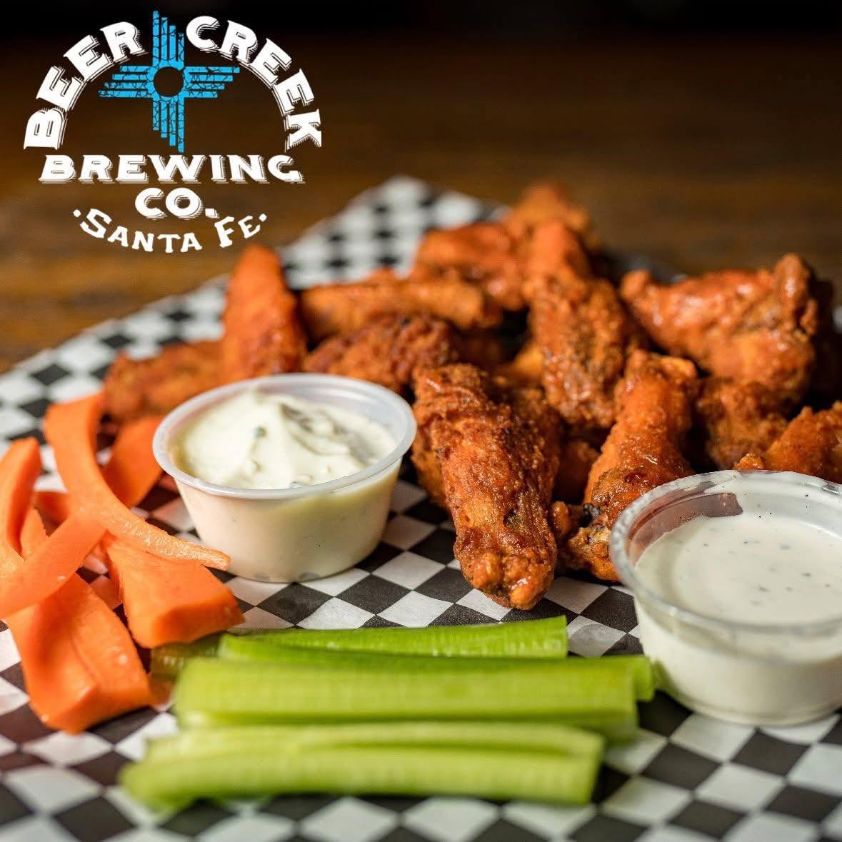 Chicken wings with celery, carrots, ranch dressing and bleu cheese dressing