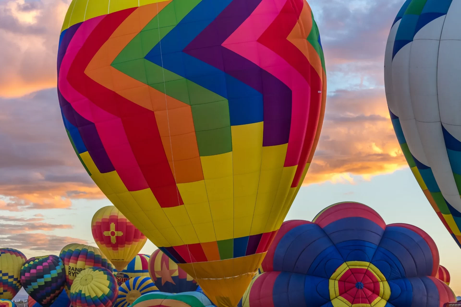 Colorful hot air balloons filling the sky at sunrise