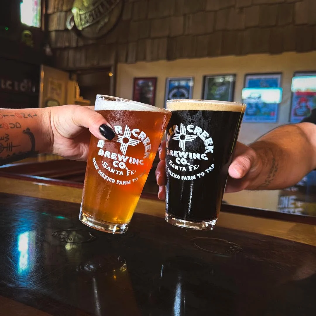 Two Beer Creek Brewing Company beers raised together inside the Santa Fe brewery