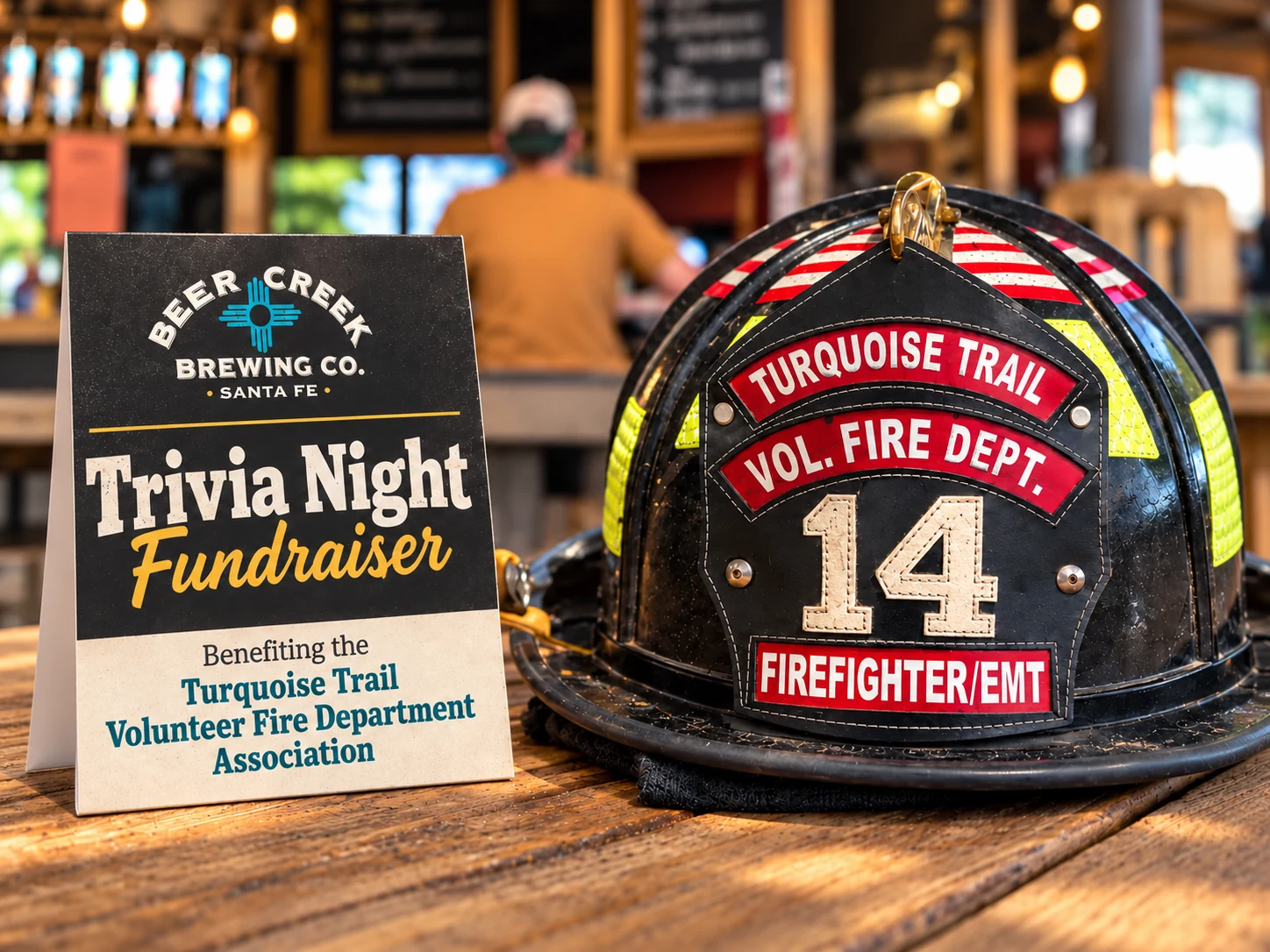 Turquoise Trail Volunteer Fire Department Association firefighter helmet beside a Beer Creek Brewing Company beer